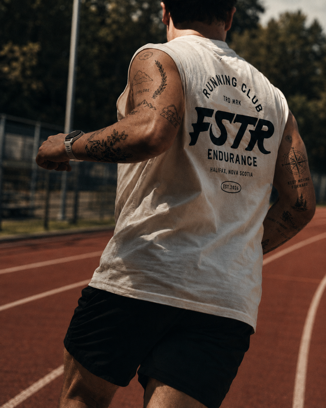 FSTR Endurance Running Club logo on apparel — a runner on a red track wearing the white FSTR Endurance sleeveless shirt, showing the full Running Club badge with Halifax, Nova Scotia and Est. 2026.