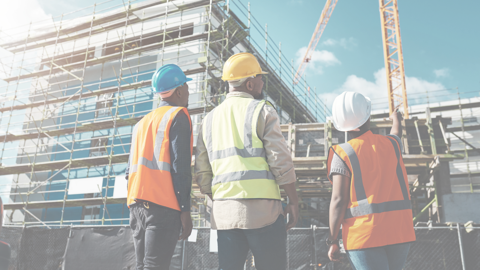 Construction workers looking at a building