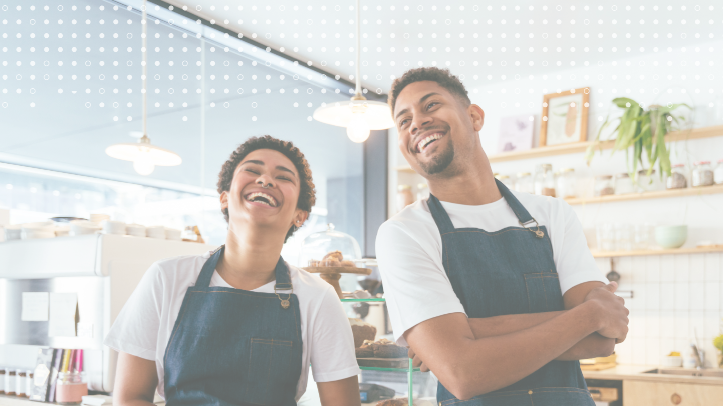 Two people smiling at a cafe