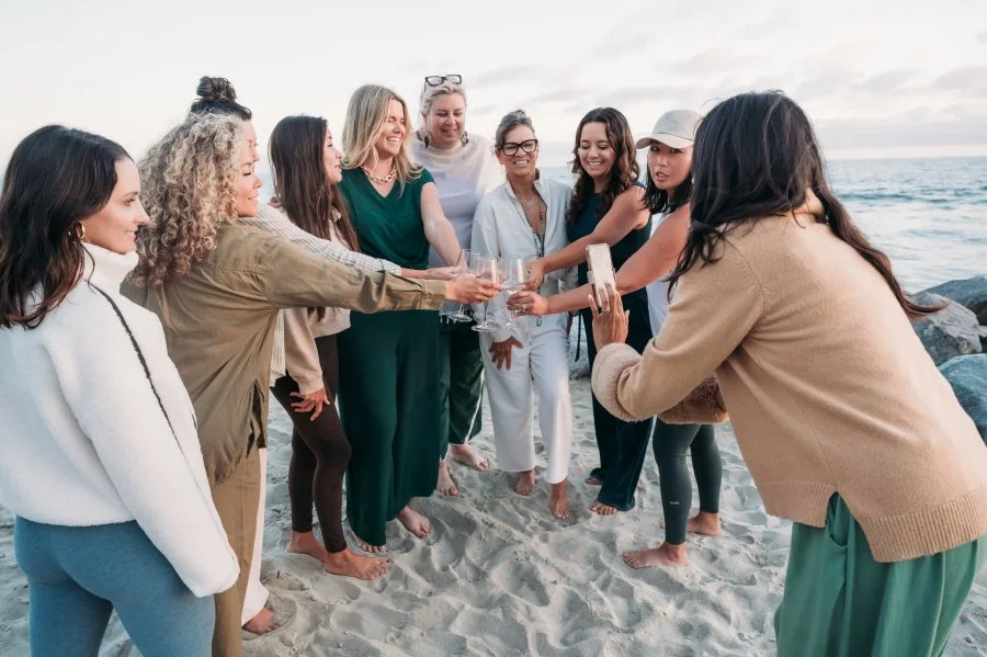Jazmin and Bizz Bitch Community members celebrating together during a beach retreat, building connections and community among women entrepreneurs.