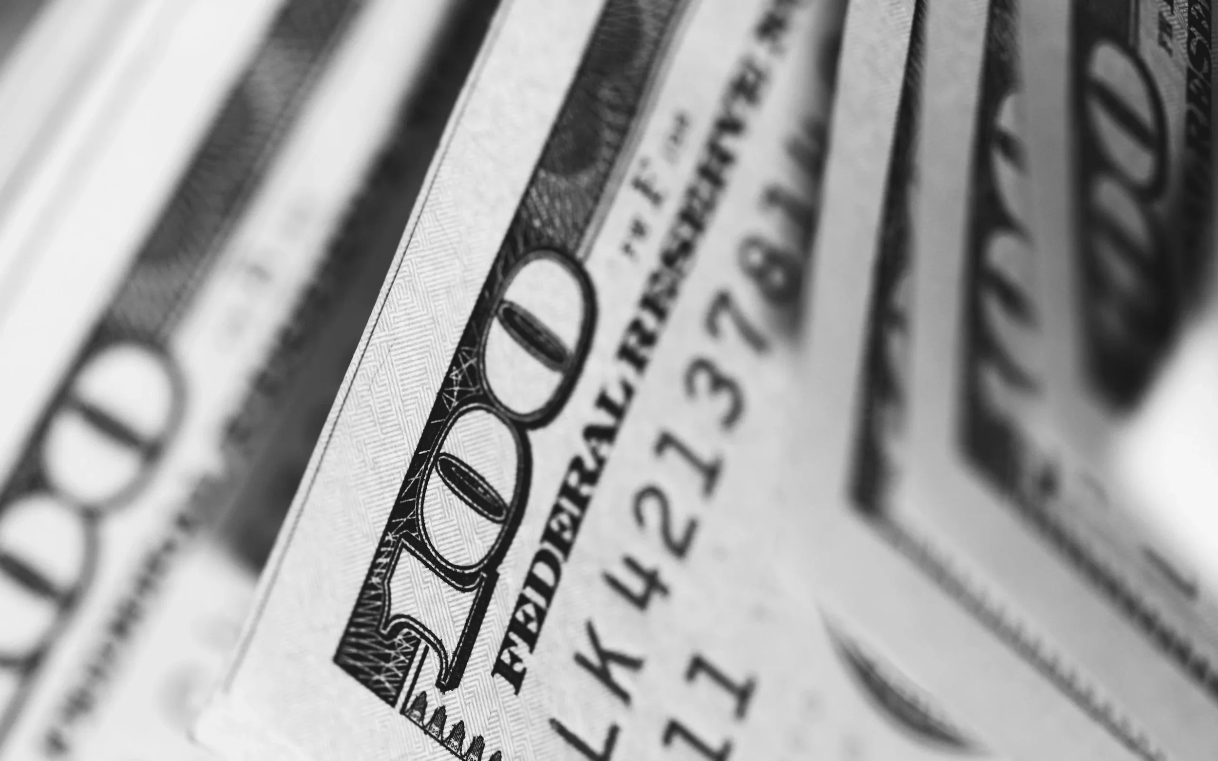 Close-up of US dollar bills representing business revenue, cash flow, and financial growth in online entrepreneurship.