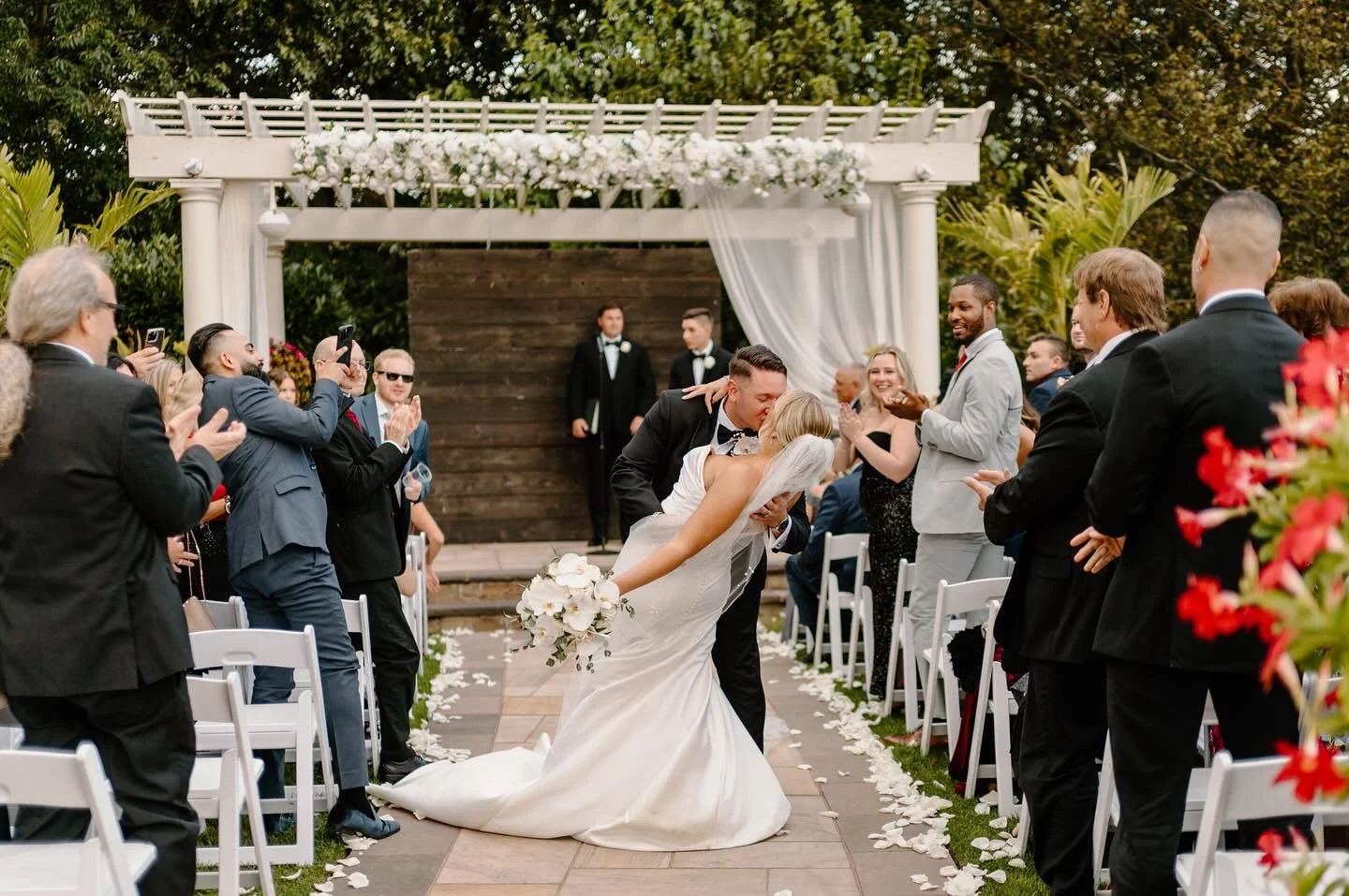 A beautiful September day celebrating Katie &amp; Sal at Giorgio&rsquo;s 🤍 Timeless white blooms with delicate orchids added a sentimental nod to their high school prom days. Once part of their corsage and boutonniere, now woven into their wedding d