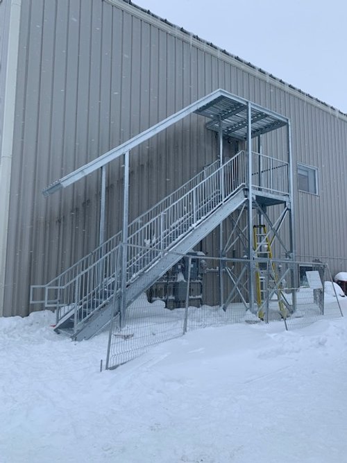 Above second floor emergency stair, galvanized.