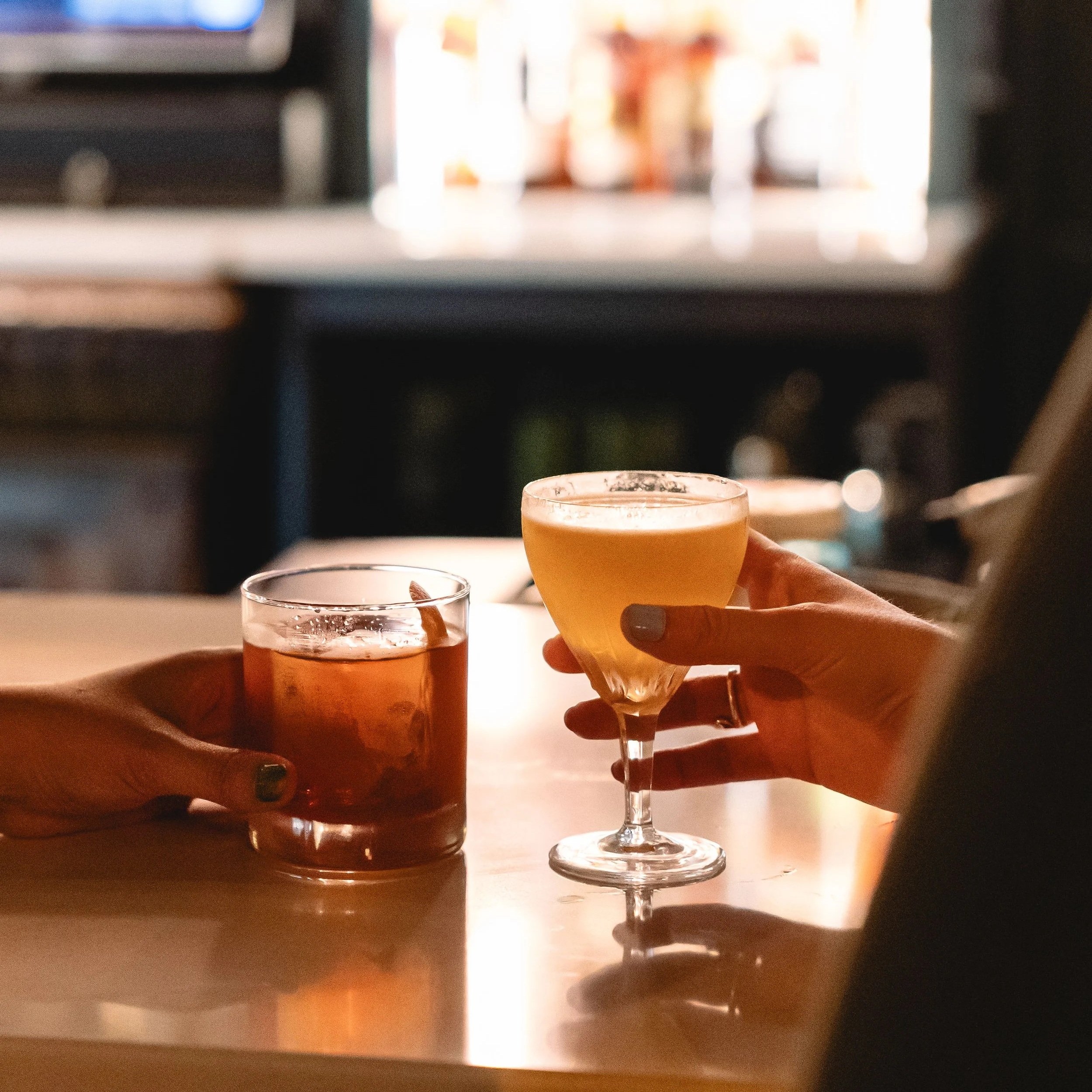 Couple clinking craft cocktails in celebration of a special anniversary at 1854 Cocktail Bar & Lounge in Cookeville TN.