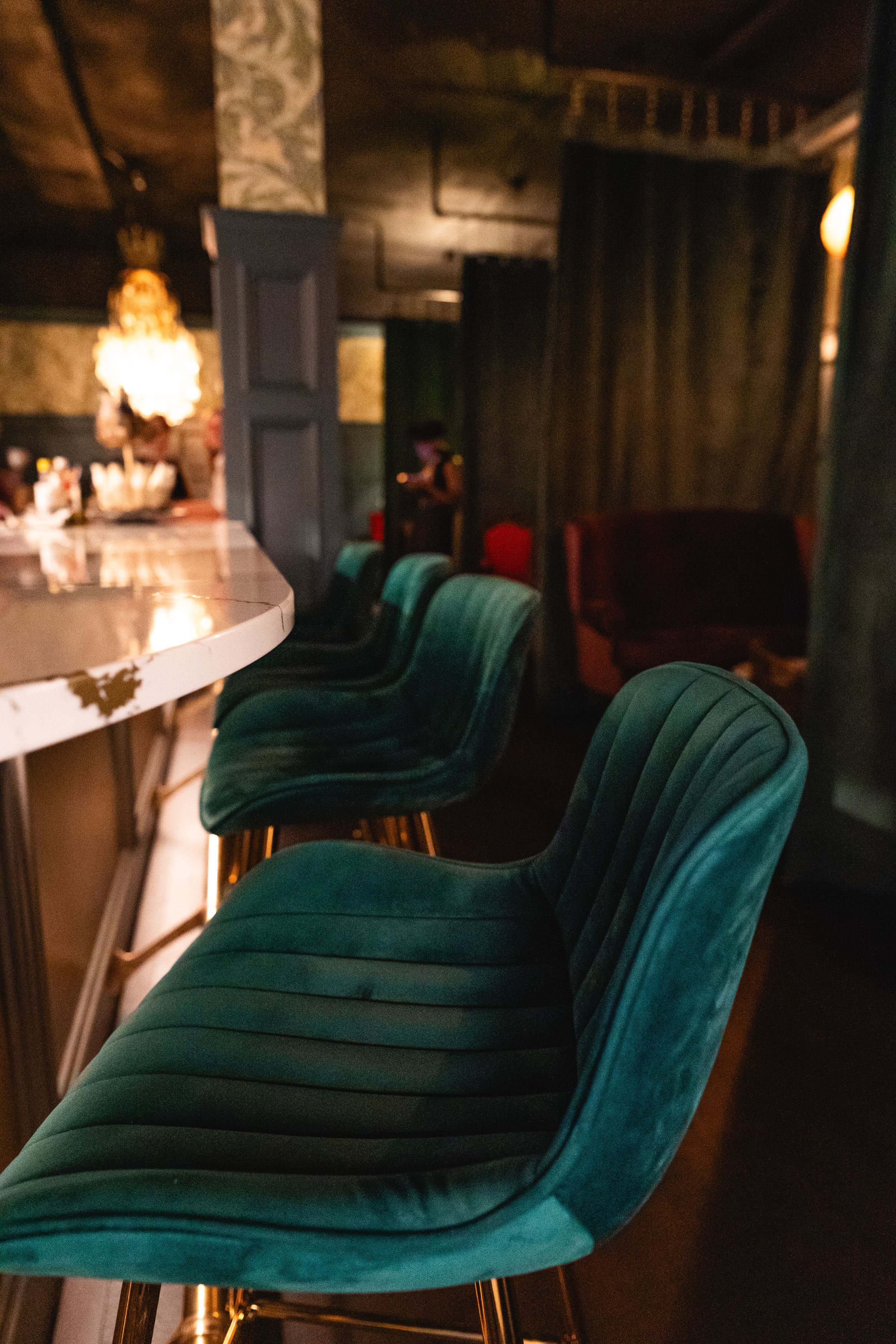 dimly lit 1854 lounge, showing bar seating
