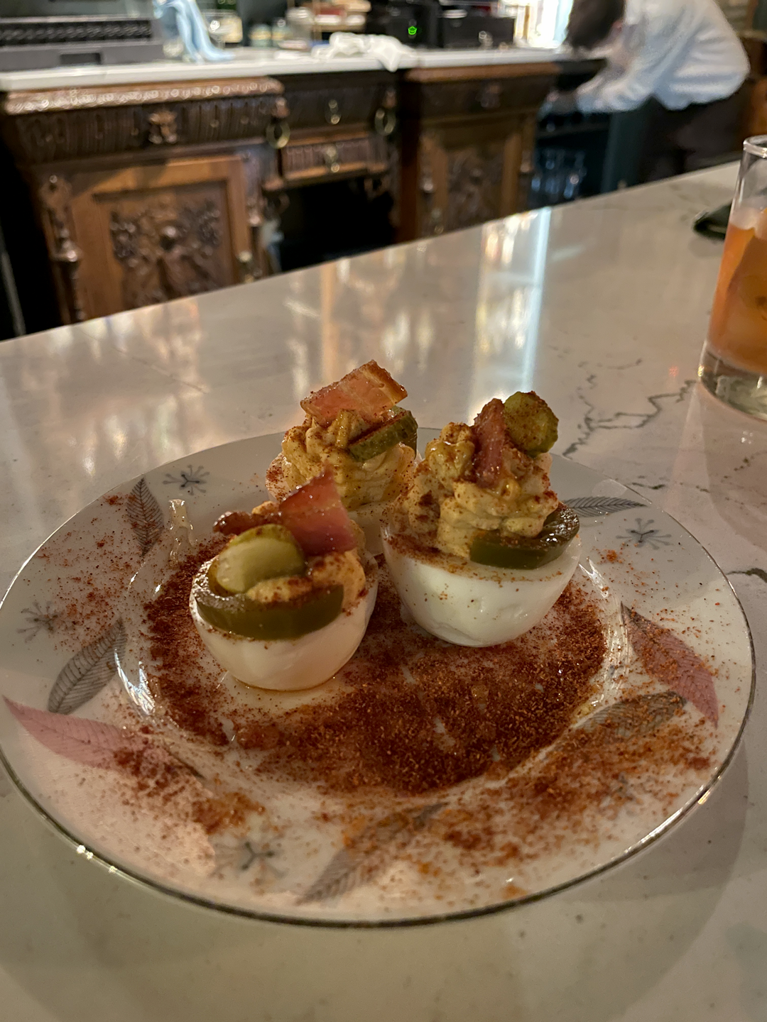 Gourmet house-made spicy deviled eggs served on a dusted plate at the bar of 1854 Cocktail Bar & Lounge in Cookeville TN.
