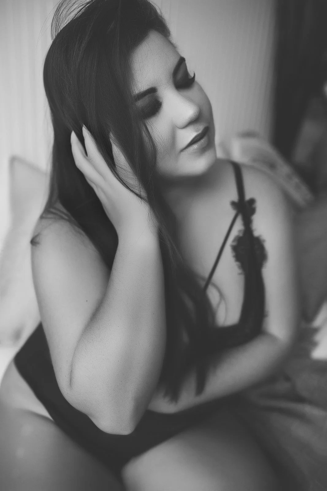 Fayetteville black and white boudoir portrait, woman with hand in her hair