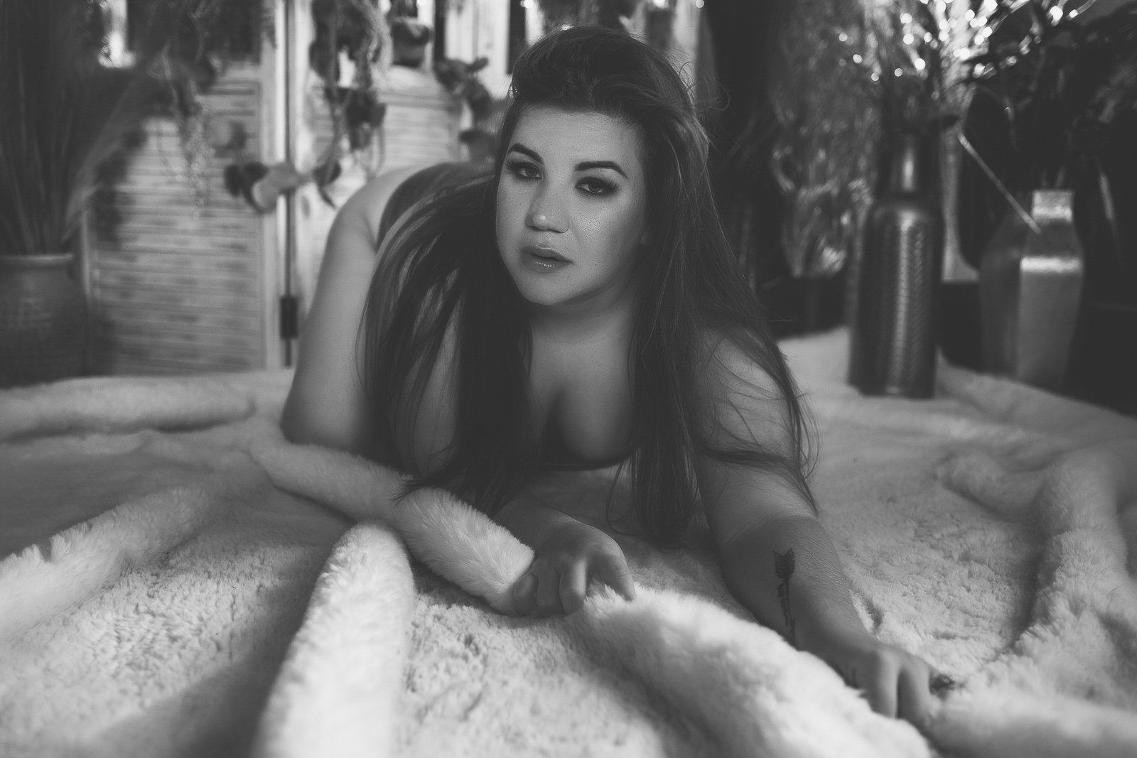 Bentonville Arkansas boudoir portrait, black and white pose lying on a soft blanket