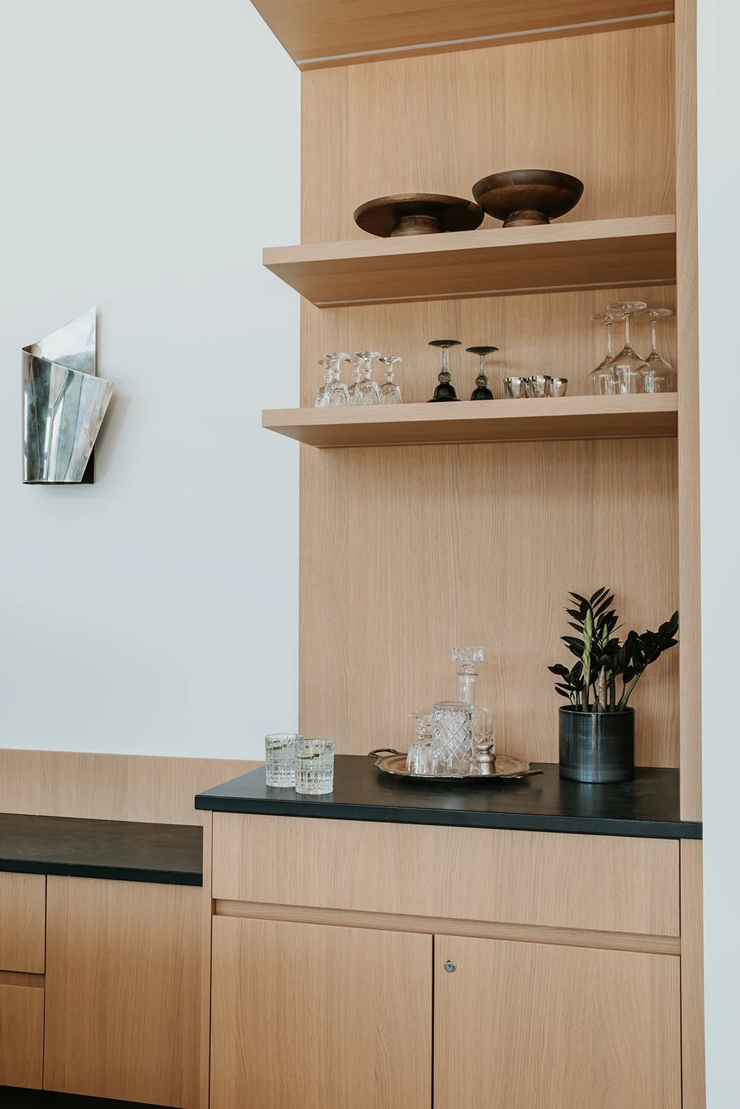 Sunstone Bar nook detail with glassware on floating shelves, new-build interior design in Pemberton, BC by LRD Studio. Photography by Darby Magill.