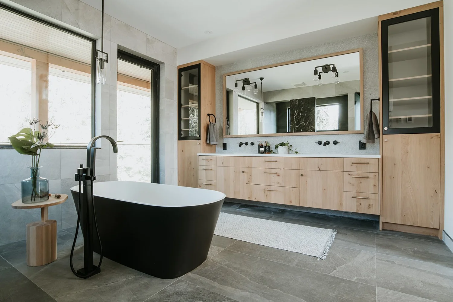 Balsam Oak front door with sidelights, full wood-paneled walls, angled slate tile floor — new-build interior design in Whistler, BC by LRD Studio. Photography by Darby Magill.