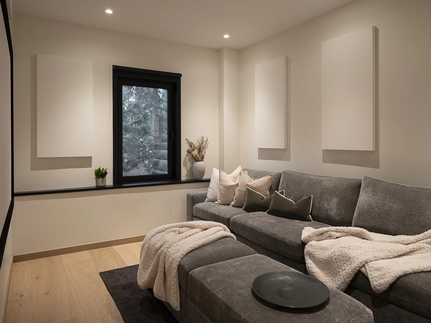 Sunridge Stair glass railing against stone, log post — renovation interior design in Whistler, BC by LRD Studio. Photography by Matt Anthony.