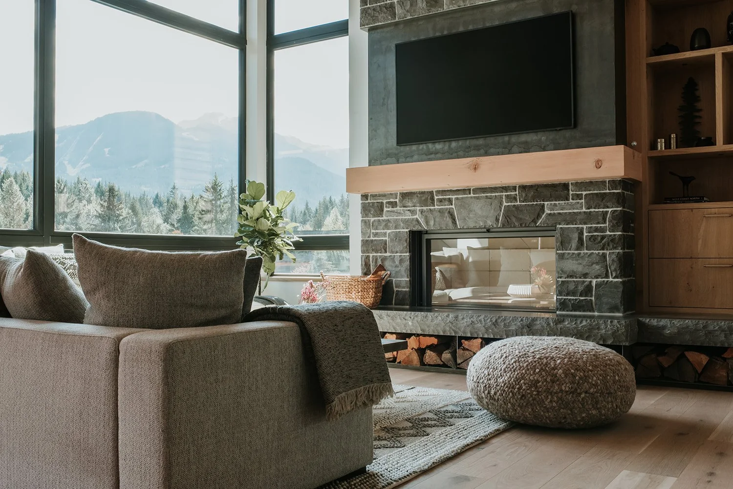 Balsam Kingston slate fireplace detail, oak mantel, firewood storage — new-build interior design in Whistler, BC by LRD Studio. Photography by Darby Magill.