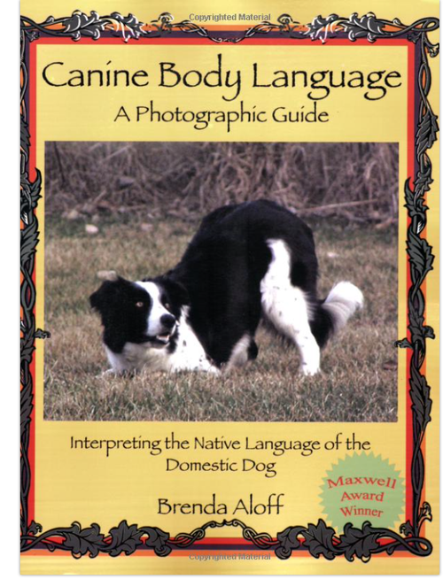Book cover of 'Canine Body Language: A Photographic Guide' by Brenda Aloff, featuring a black and white dog in a grassy area, surrounded by decorative borders.
