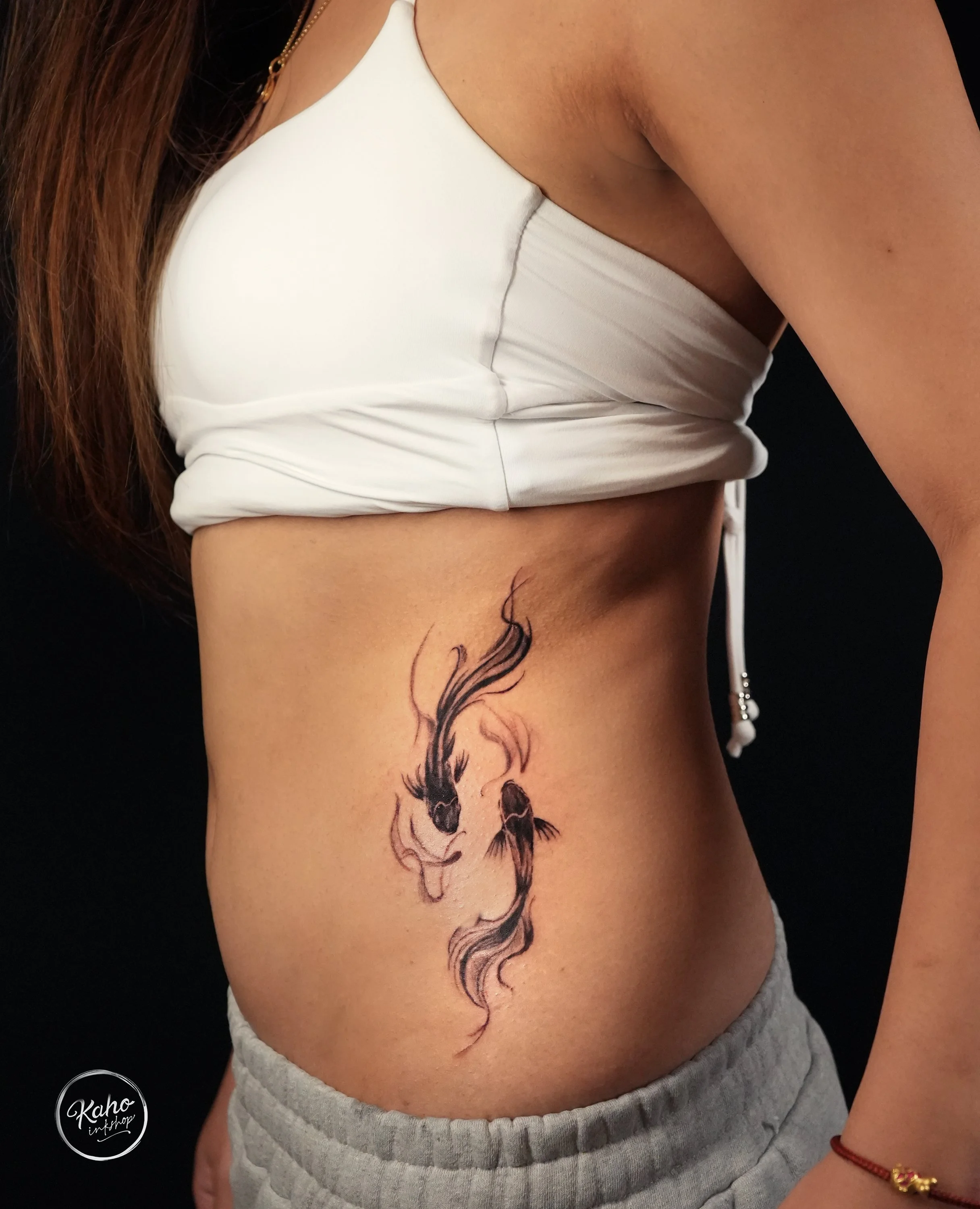 Brush stroke style koi fish tattoo on rib, minimal design in nice ink flow tattoo design and crafted by kaho inkshop, located in Los Angeles