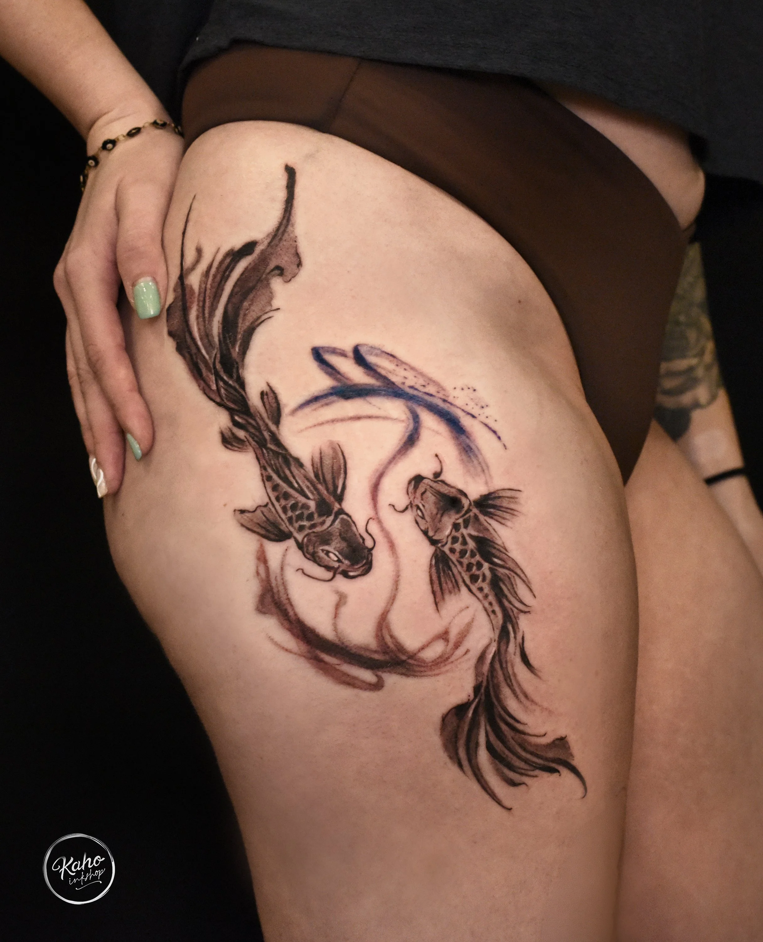 Brush stroke style koi fish tattoo on thigh, with blue ink as accent, design and crafted by kaho inkshop, located in Los Angeles