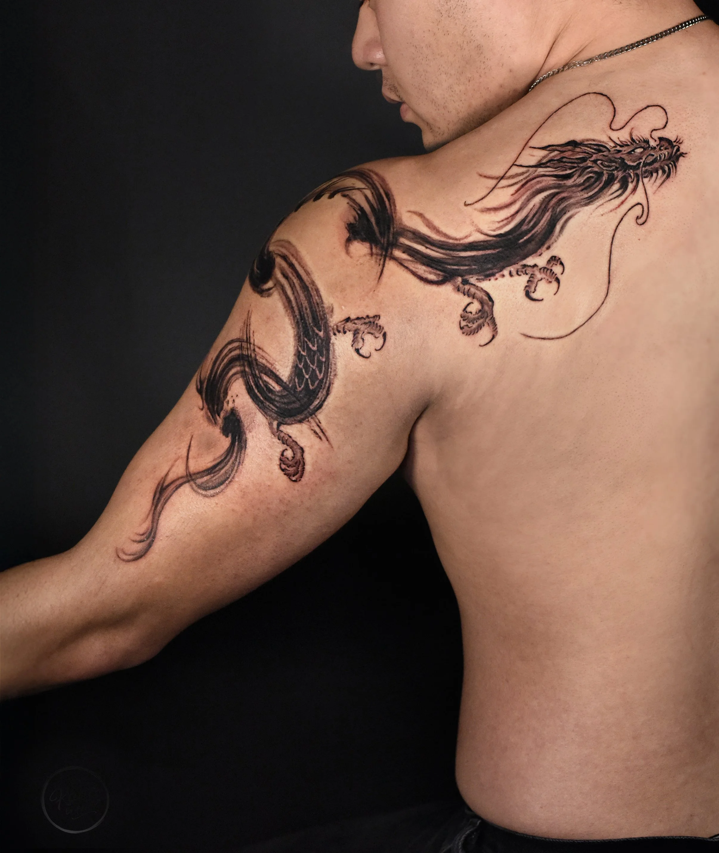 dragon in brush stroke tattoo, Full upper arm  along to the shoulder tattoo  
design and crafted by kaho inkshop, tattoo artist based in los angeles