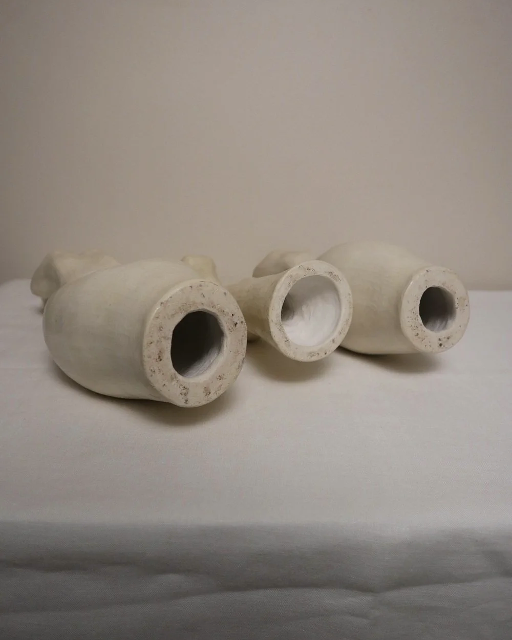 Set of three white ceramic abstract sculptures in the shape of the female form. Unknown age.  Signed 'R W Art / RoseWood Art'