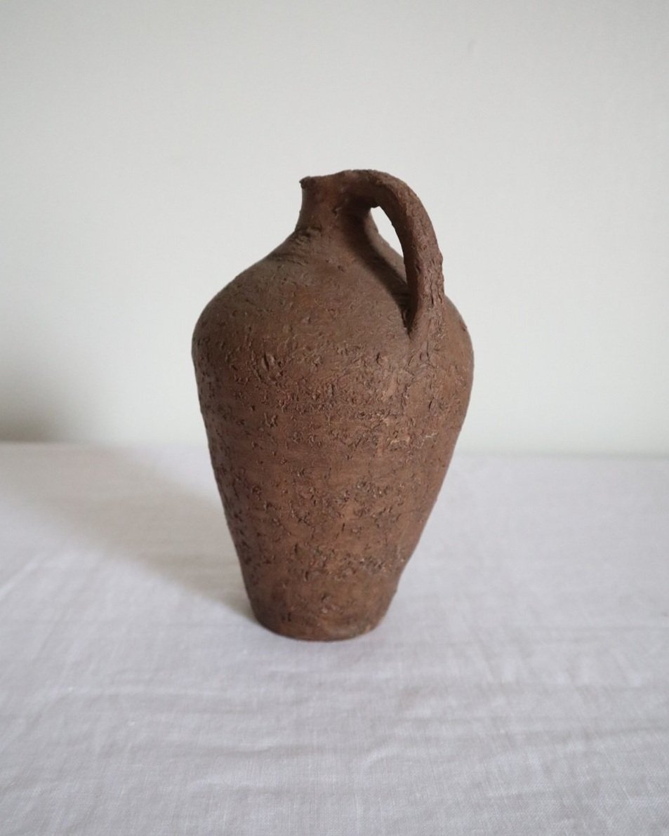 Mid century Brutalist sculptural textured brown ceramic decorative vessel or bud vase. Circa 1970s. Signed “CP”, likely the work of American potter Karl Martz for Clayburn Pottery.