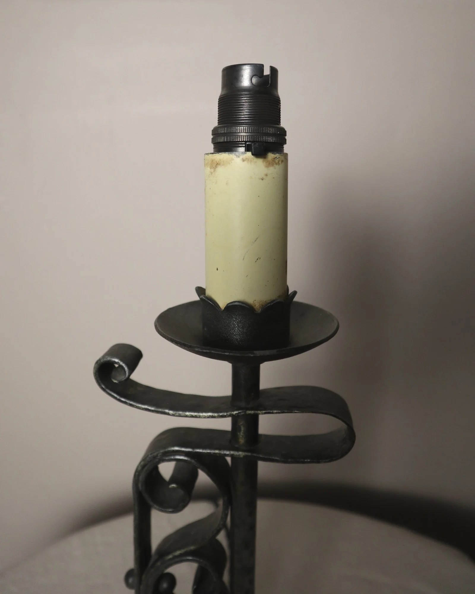 Vintage Art Deco style metal candlestick table lamp with elegant scroll detailing.
