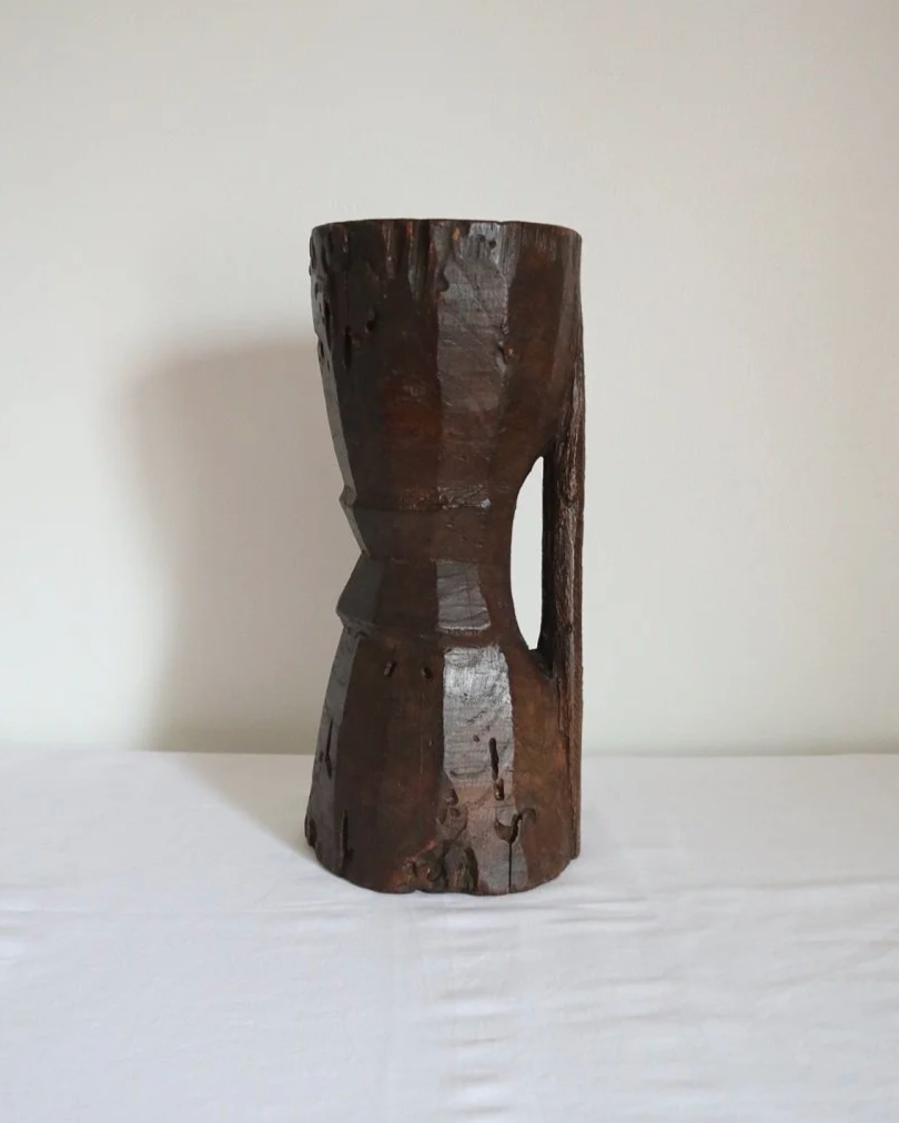 Heavy primitive sculptural carved wooden mortar with handle.