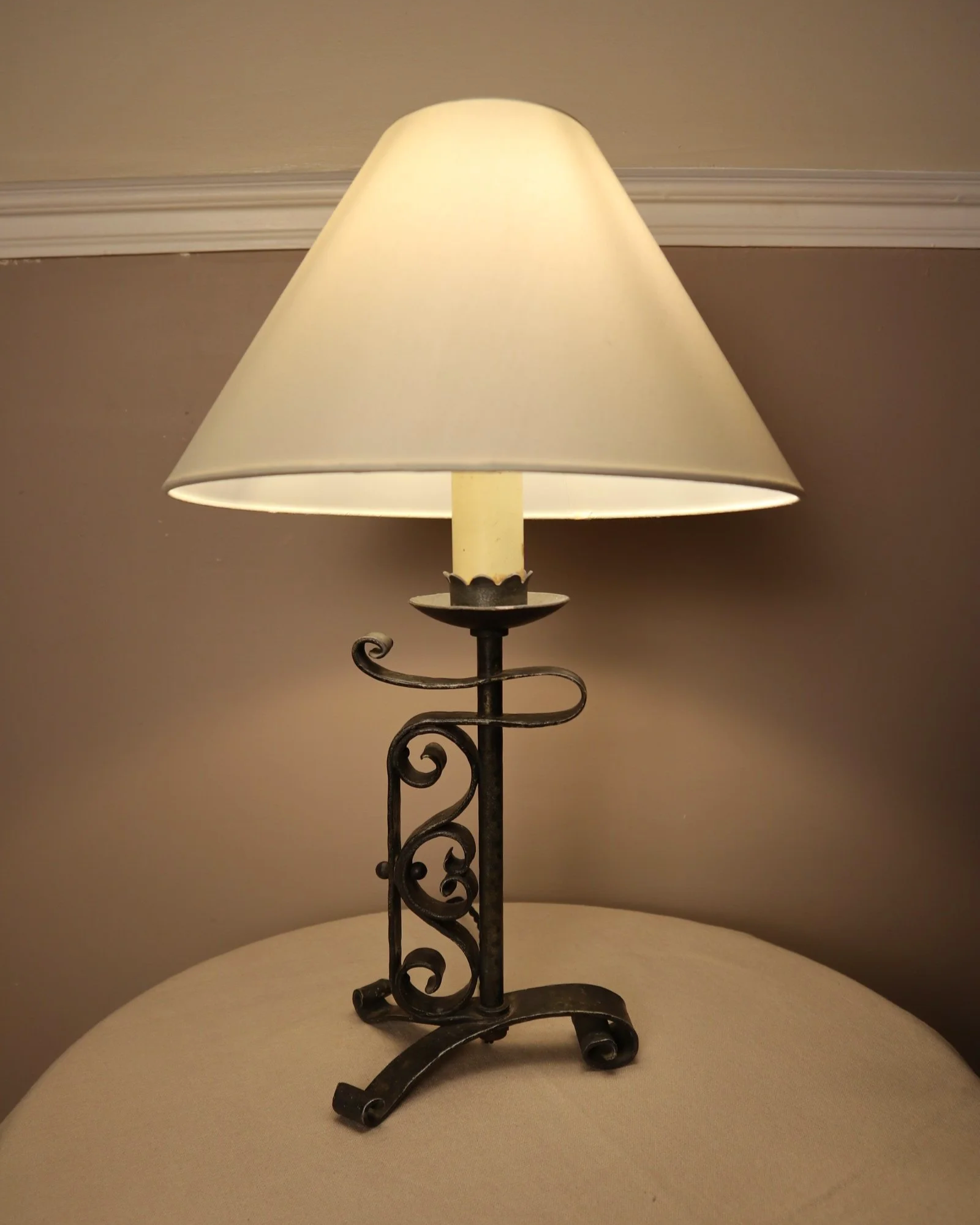 Vintage Art Deco style metal candlestick table lamp with elegant scroll detailing.