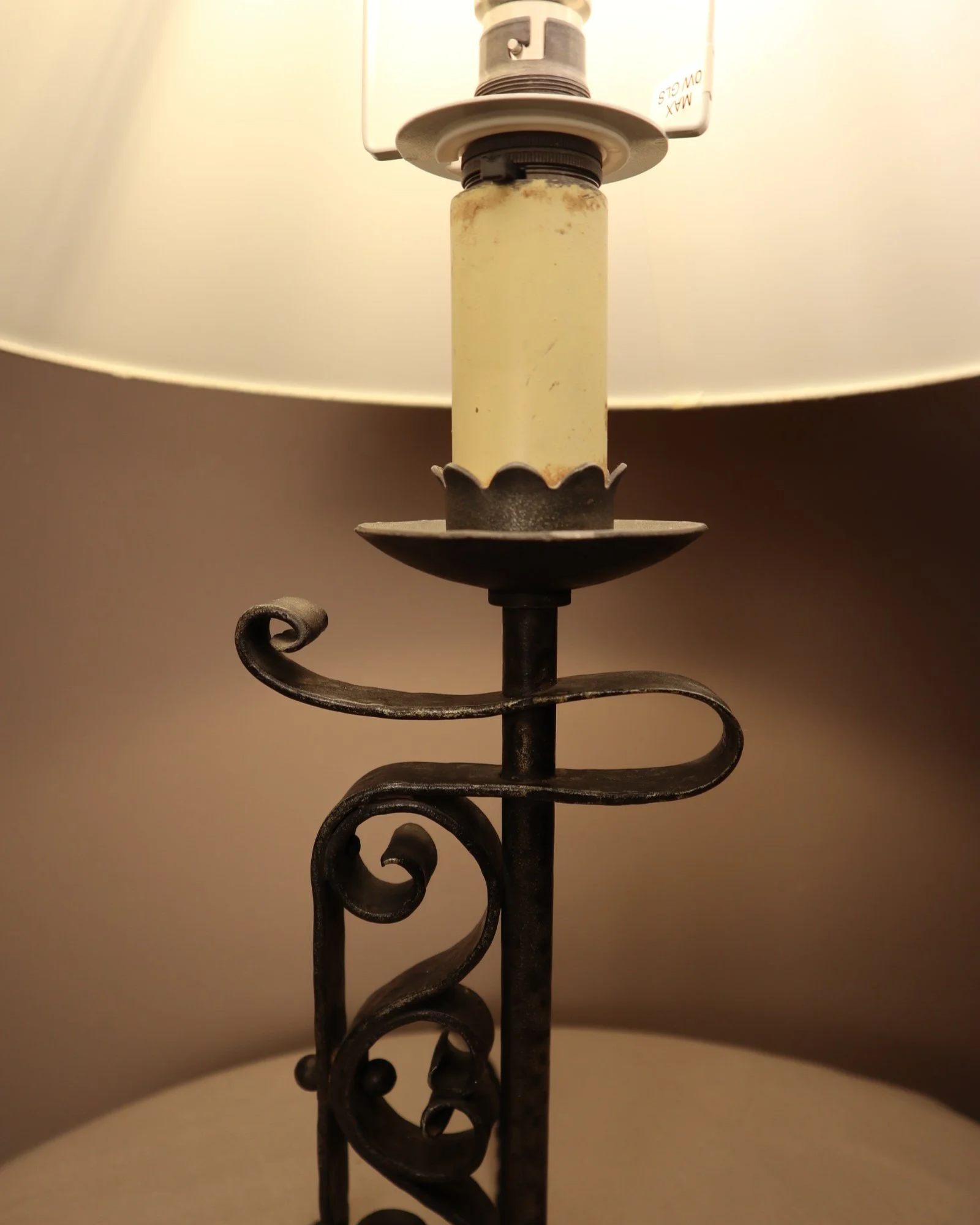 Vintage Art Deco style metal candlestick table lamp with elegant scroll detailing.