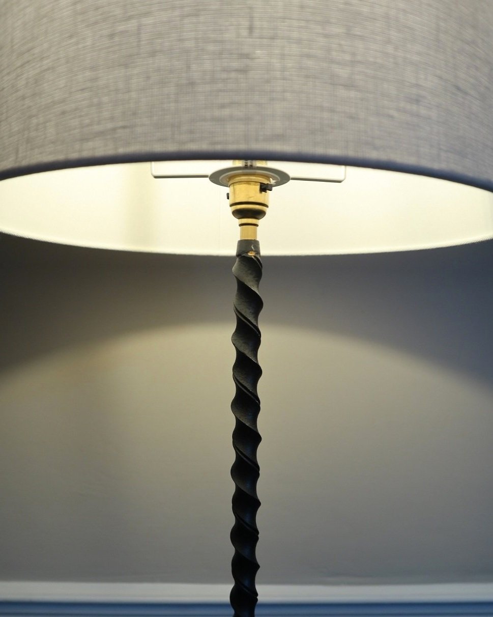 French wrought iron floor lamp with twisted corkscrew column and tripod base. Circa 1950s.