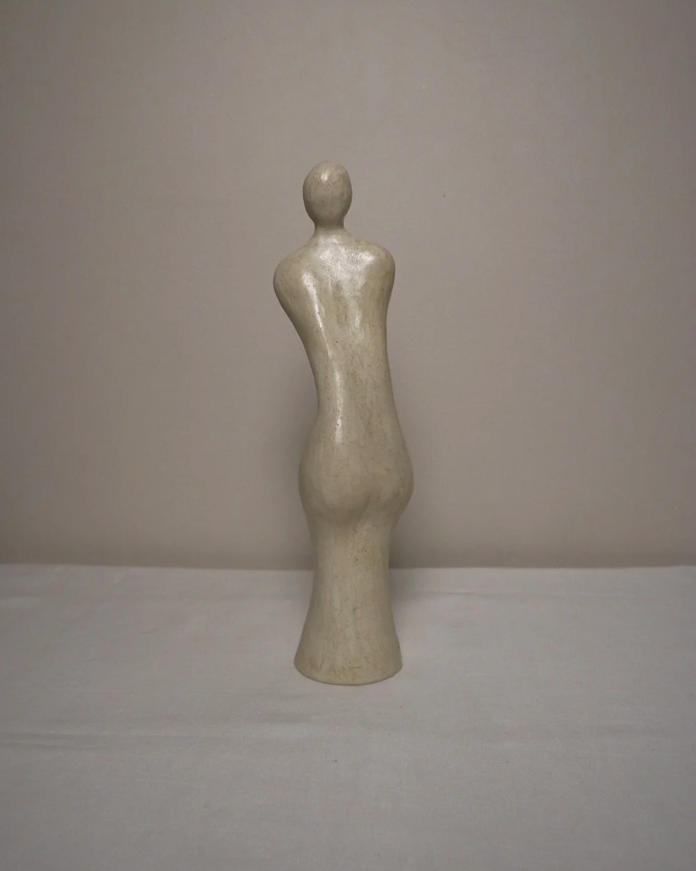 Set of three white ceramic abstract sculptures in the shape of the female form. Unknown age.  Signed 'R W Art / RoseWood Art'