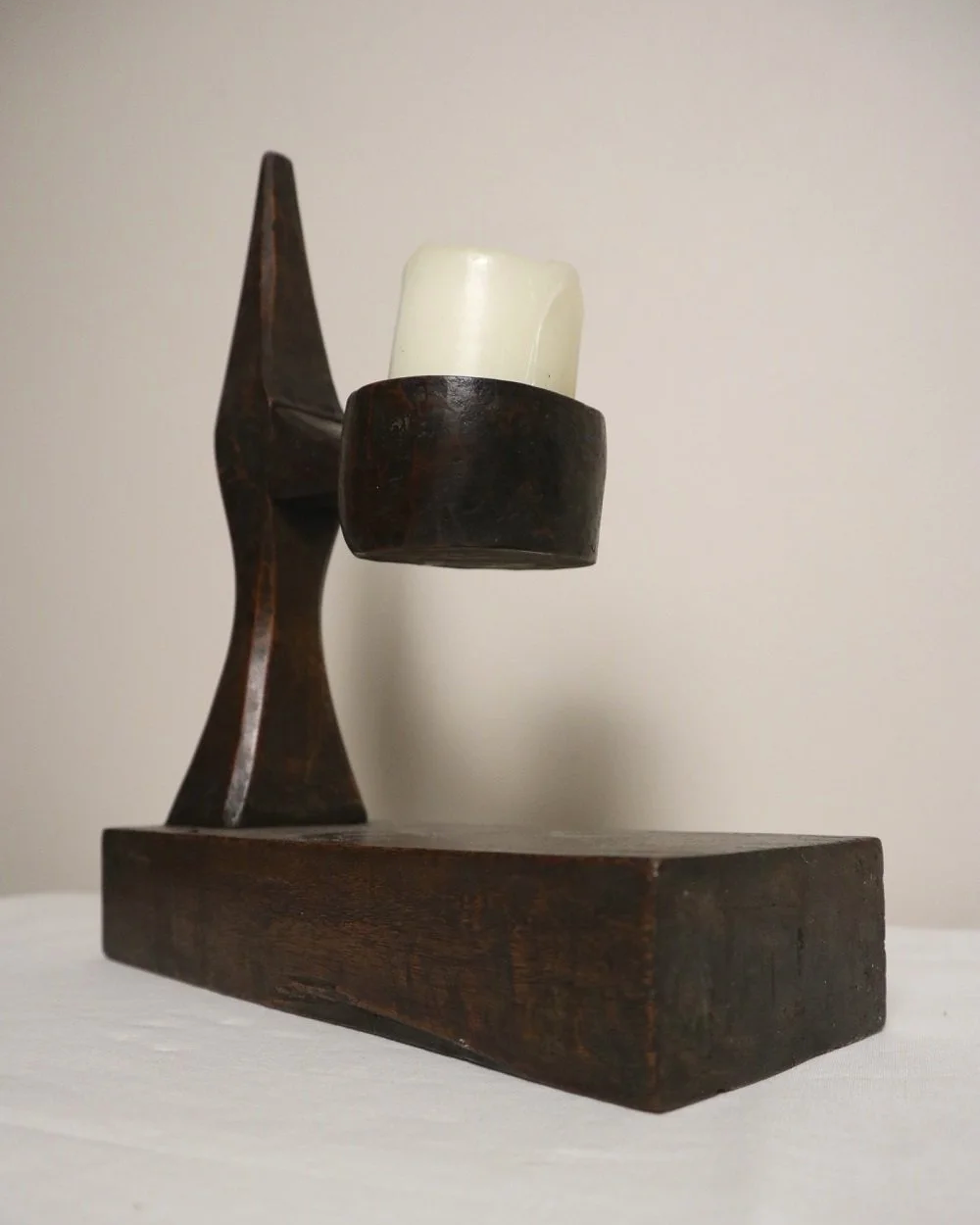 American hand carved dark wooden Brutalist candleholder with block base.
