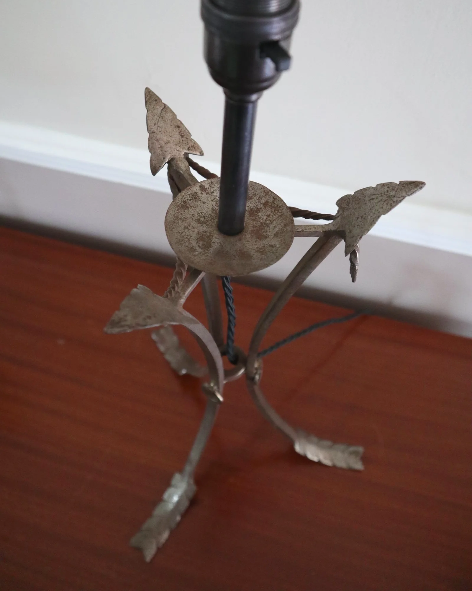 Pair of French style mid century metal tripod table lamps featuring three arrows.