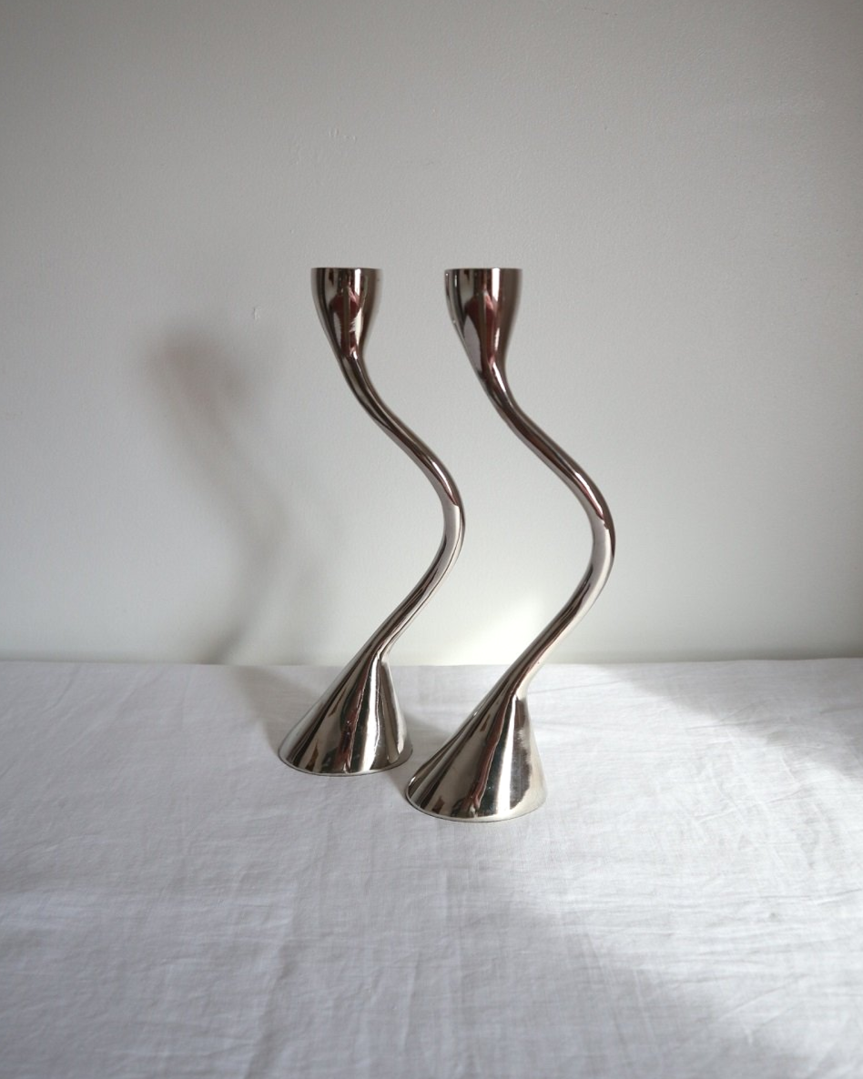 Pair of sculptural solid aluminium candleholders, circa 1970s.