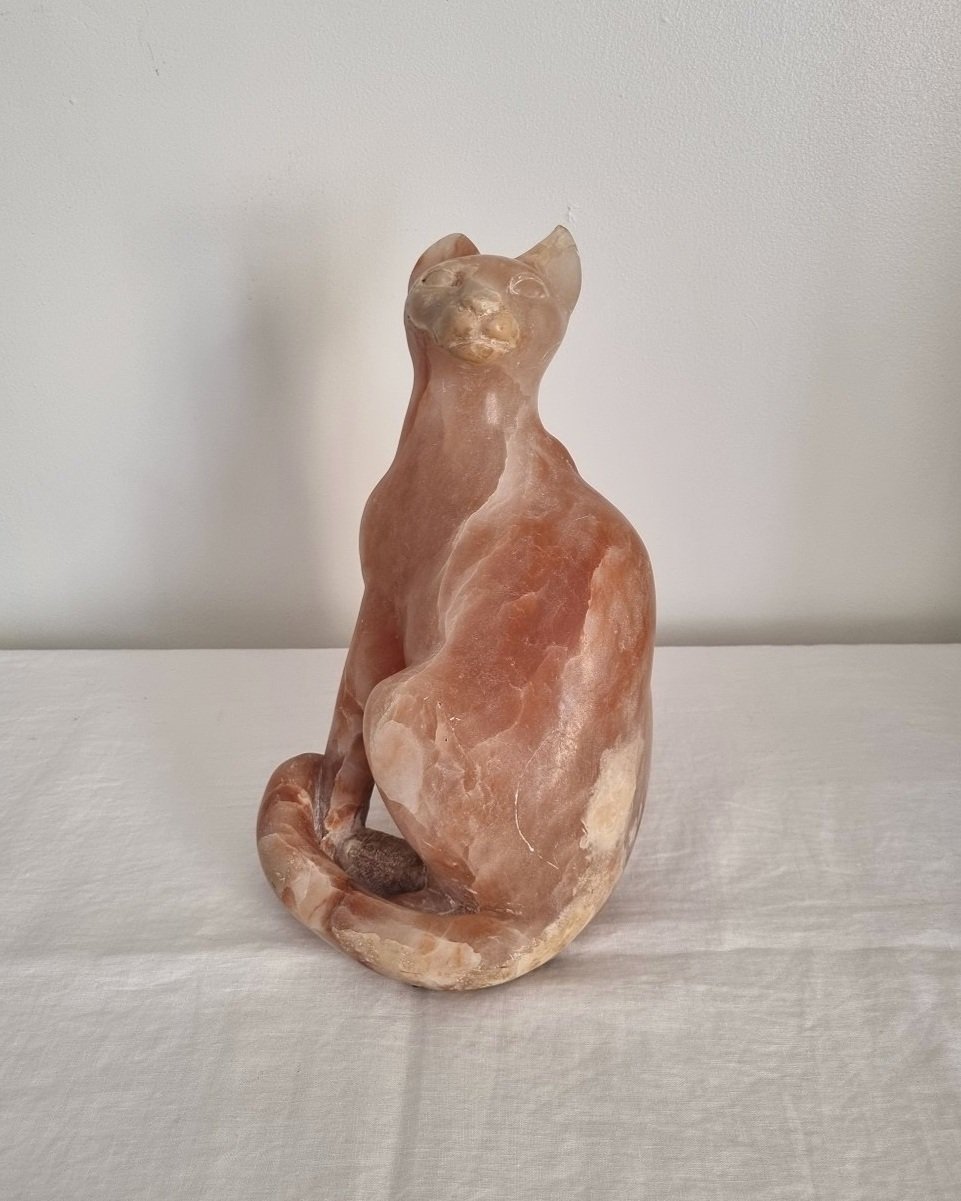 Vintage, heavy hand carved soft pink alabaster cat with striking natural grain and smooth lines.