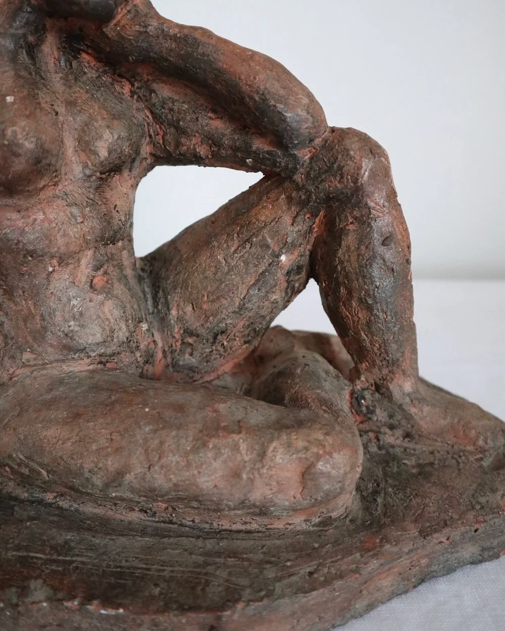 Heavy handmade studio pottery textured sculpture of seated nude woman.