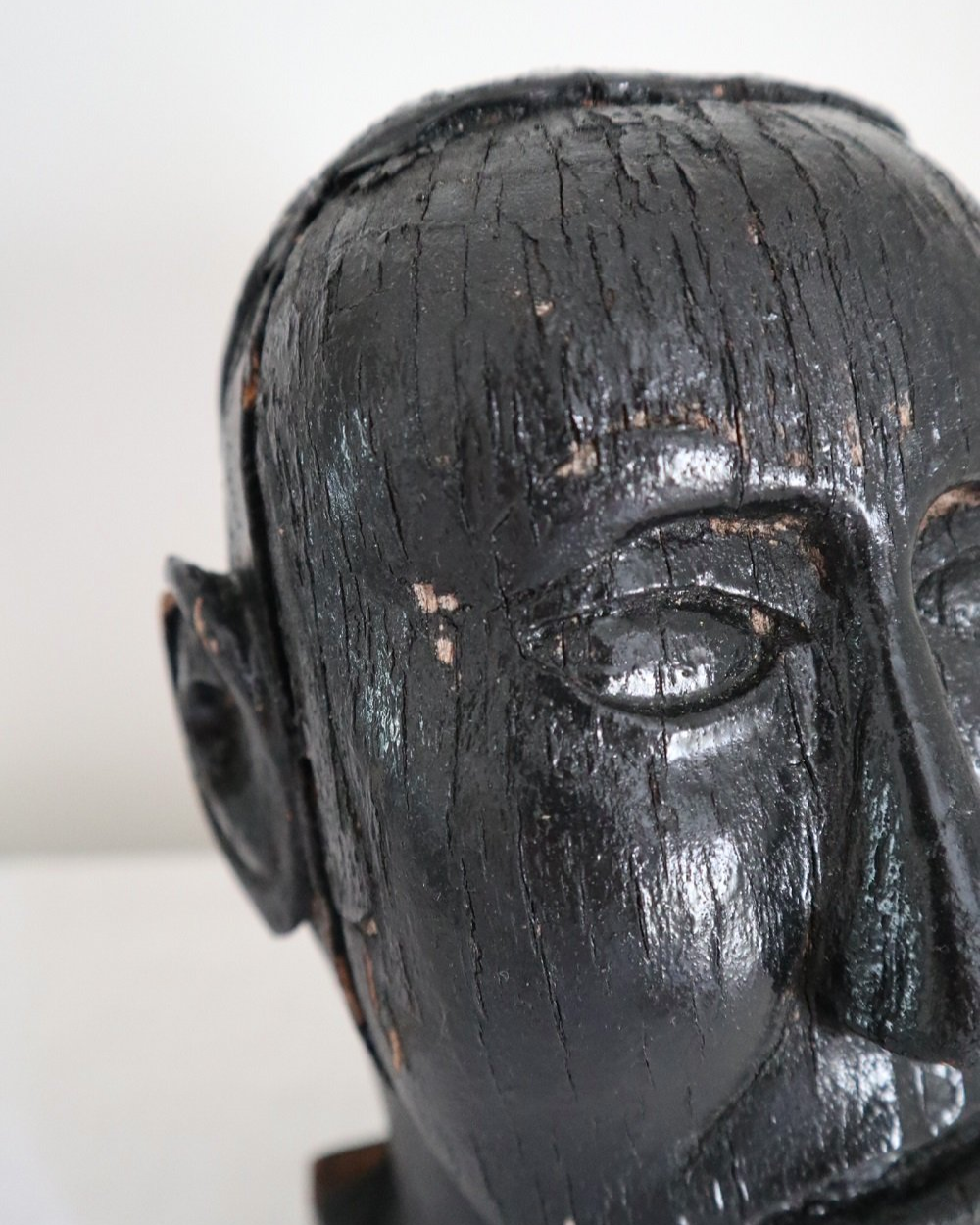 Vintage hand carved black painted wooden sculpture of male head. Age unknown.