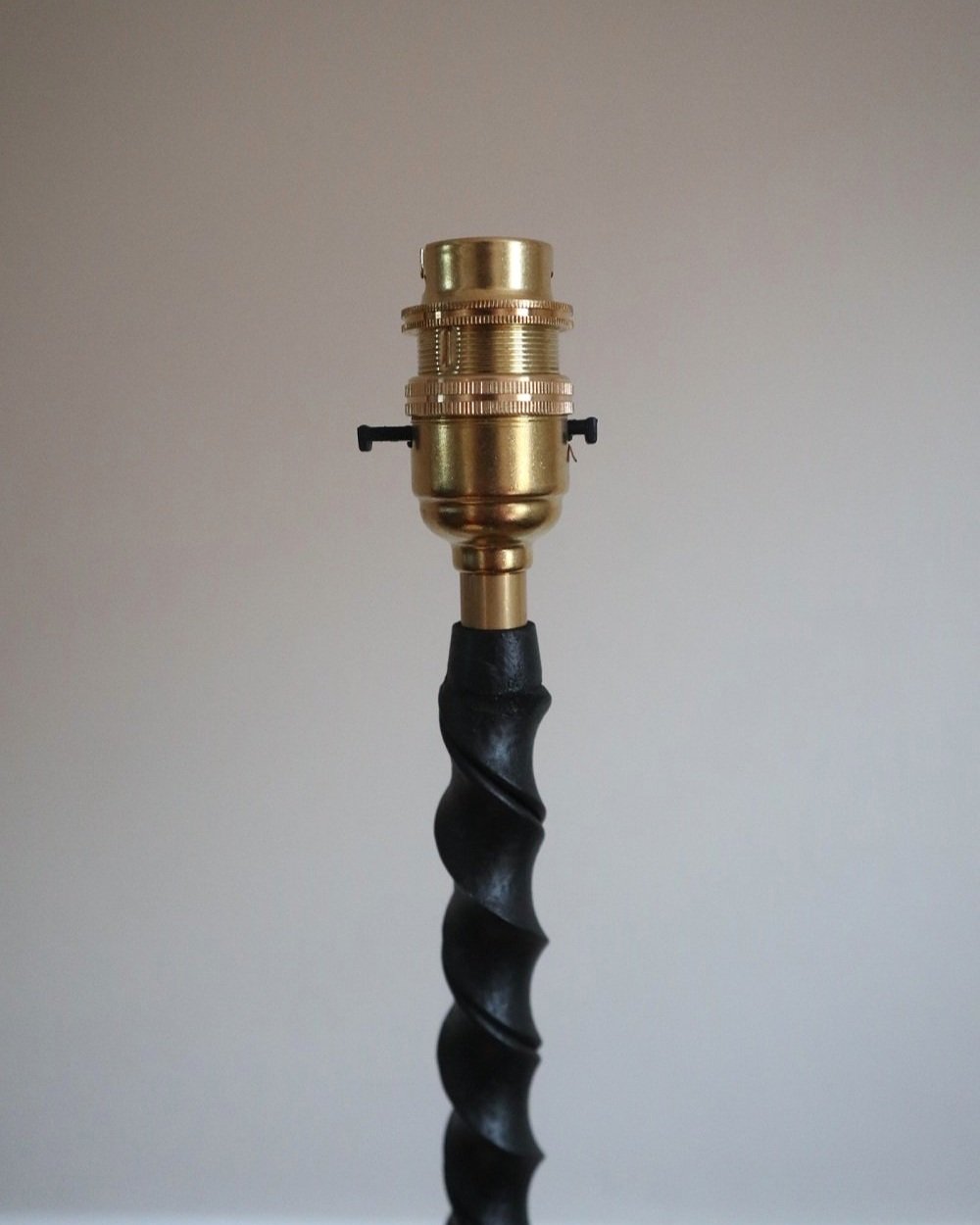 French wrought iron floor lamp with twisted corkscrew column and tripod base. Circa 1950s.