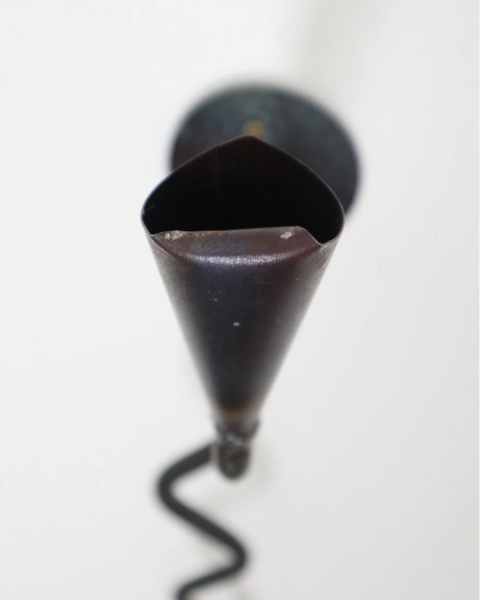 Large Swedish black iron wall sconce candleholder with wavy design. Circa 1960s.