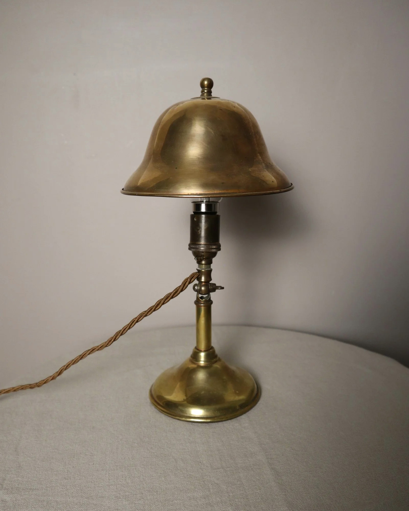 Small, vintage adjustable brass worker's desk lamp. Can be freestanding or attached to the edge of a workbench etc with clamp.