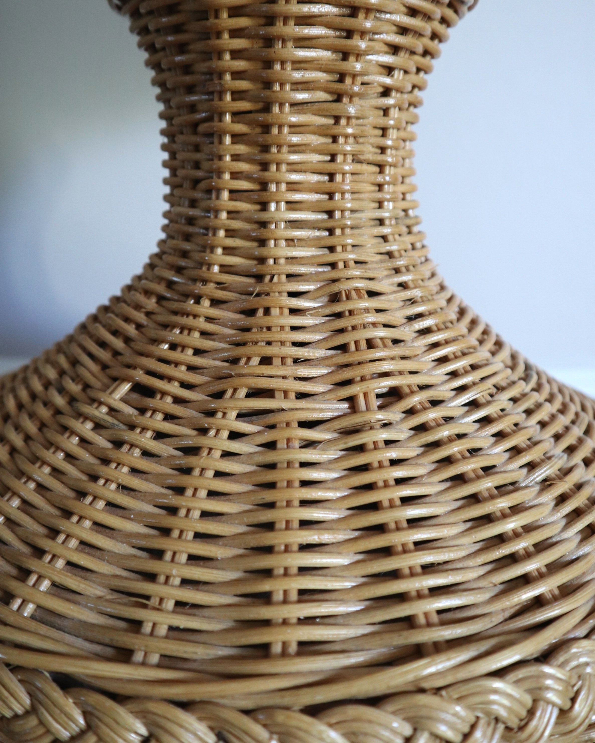 20th Century woven rattan floor lamp with Hollywood Regency style braided detailing.
