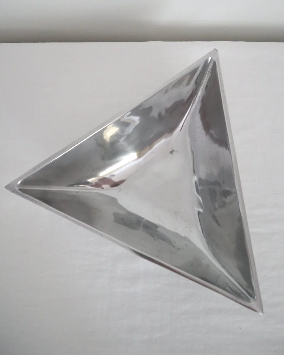 Solid shiny aluminium triangular Modernist style dish.