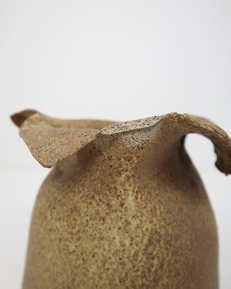 Handmade studio pottery 'paper bag' vase with speckled sand coloured surface.