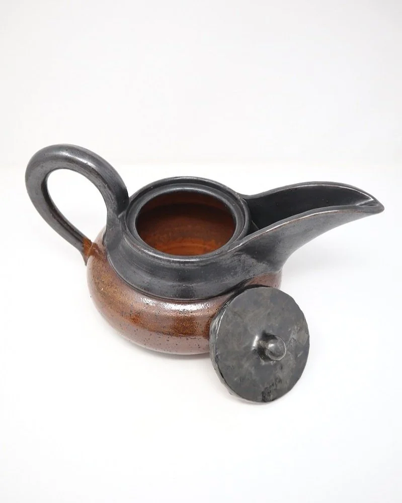 Large Art Deco ceramic tea pot with distinctive wide spout, looped handle and metallic grey and brown speckled glazing in the manner of Vally Wieselthier USA, circa 1940s.
