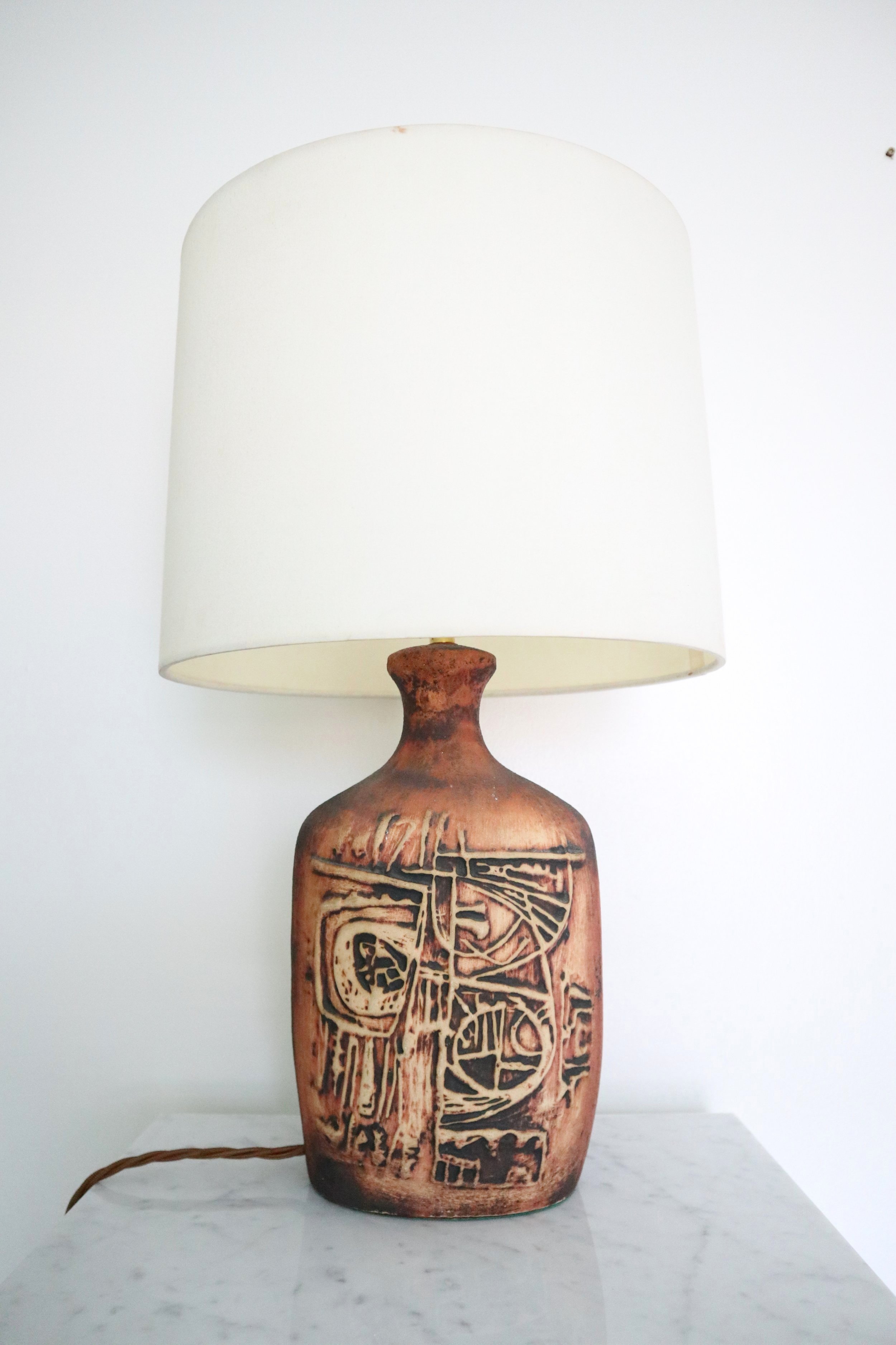 A Brutalist, Tremaen Cornish studio pottery lamp of the moulded 'Mayan Scraffito' design by Peter Ellery. Circa 1975