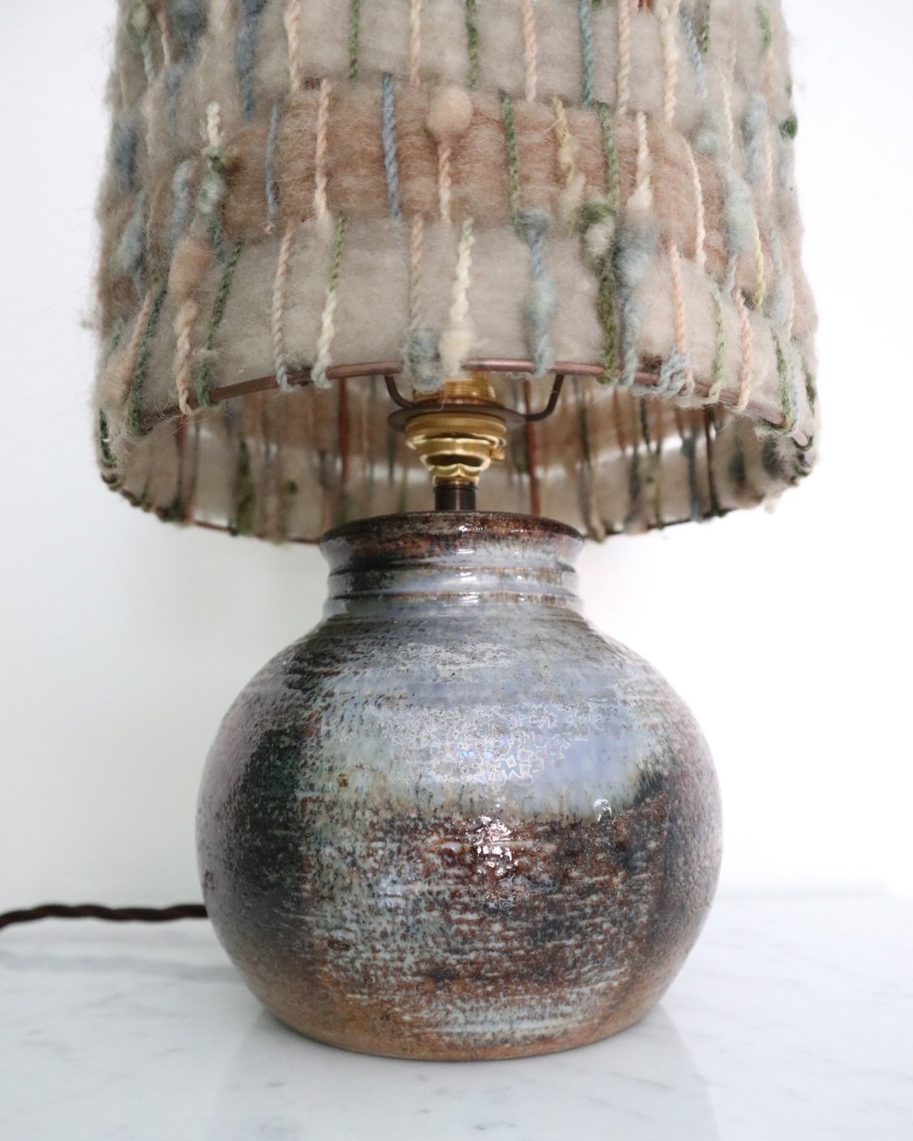 French, textured ceramic table lamp with subtle pale blue grey glazing. Signed 'Ferrieres'. Comes with original woven wool shade in neutral blue grey tones. Circa 1970s