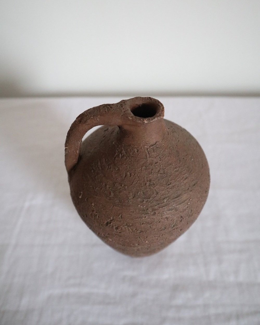 Mid century Brutalist sculptural textured brown ceramic decorative vessel or bud vase. Circa 1970s. Signed “CP”, likely the work of American potter Karl Martz for Clayburn Pottery.