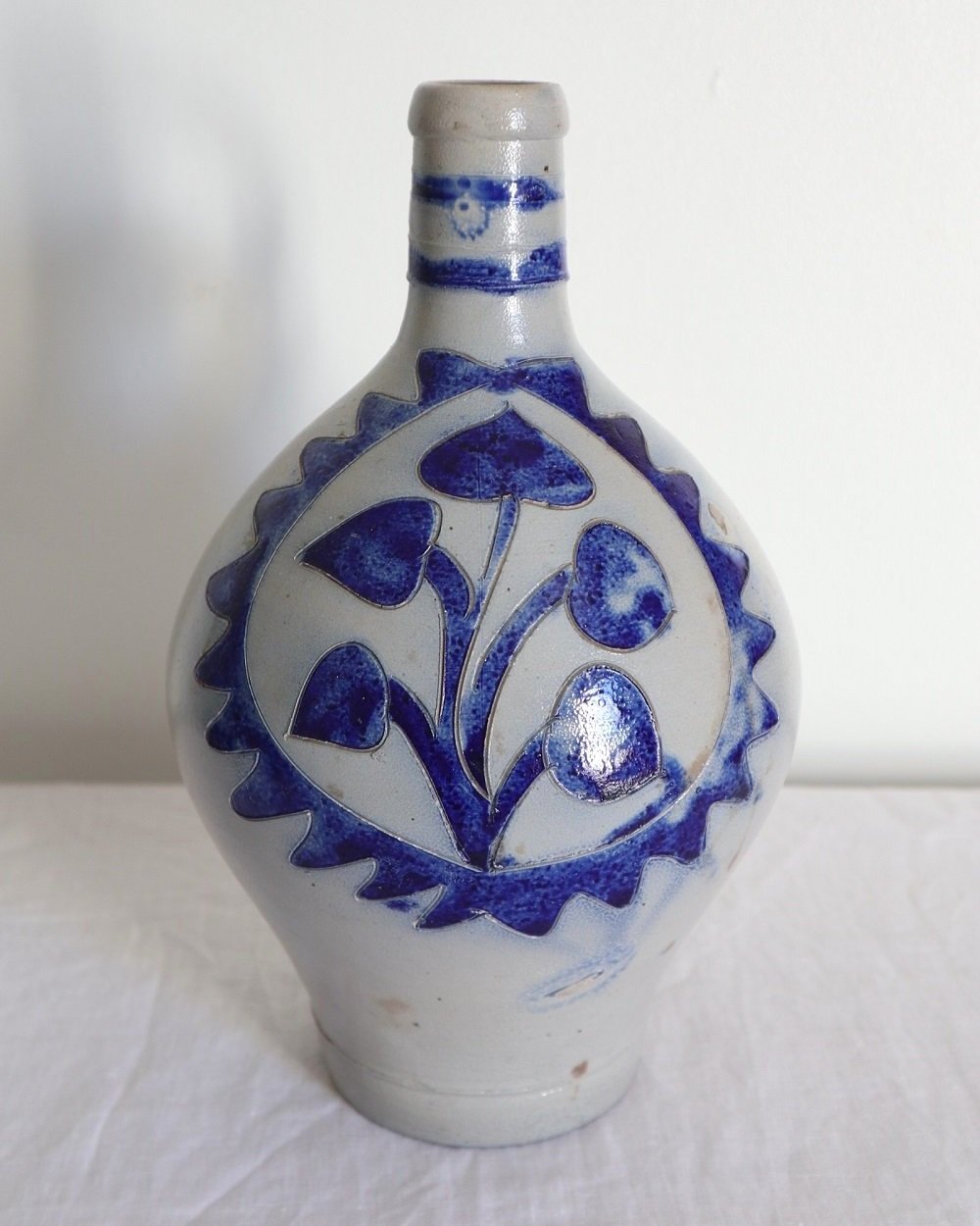 Large vintage German Westerwald salt glazed stoneware flagon with cobalt blue foliage decoration and two bands to the neck.