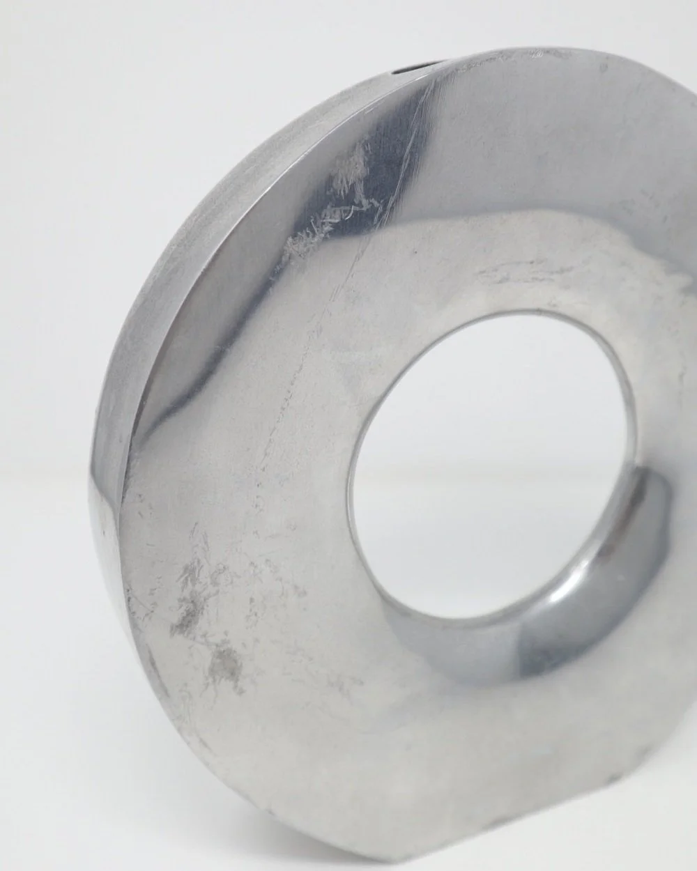 Modernist style aluminium circular doughnut decorative vase.