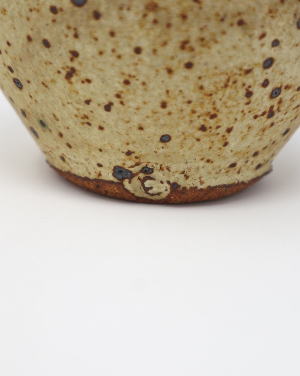 Studio pottery handmade spherical speckled vase. Rustic, textured crackled ceramic. Signed to base 'E' likely the work of Elizabeth Saunders, UK.