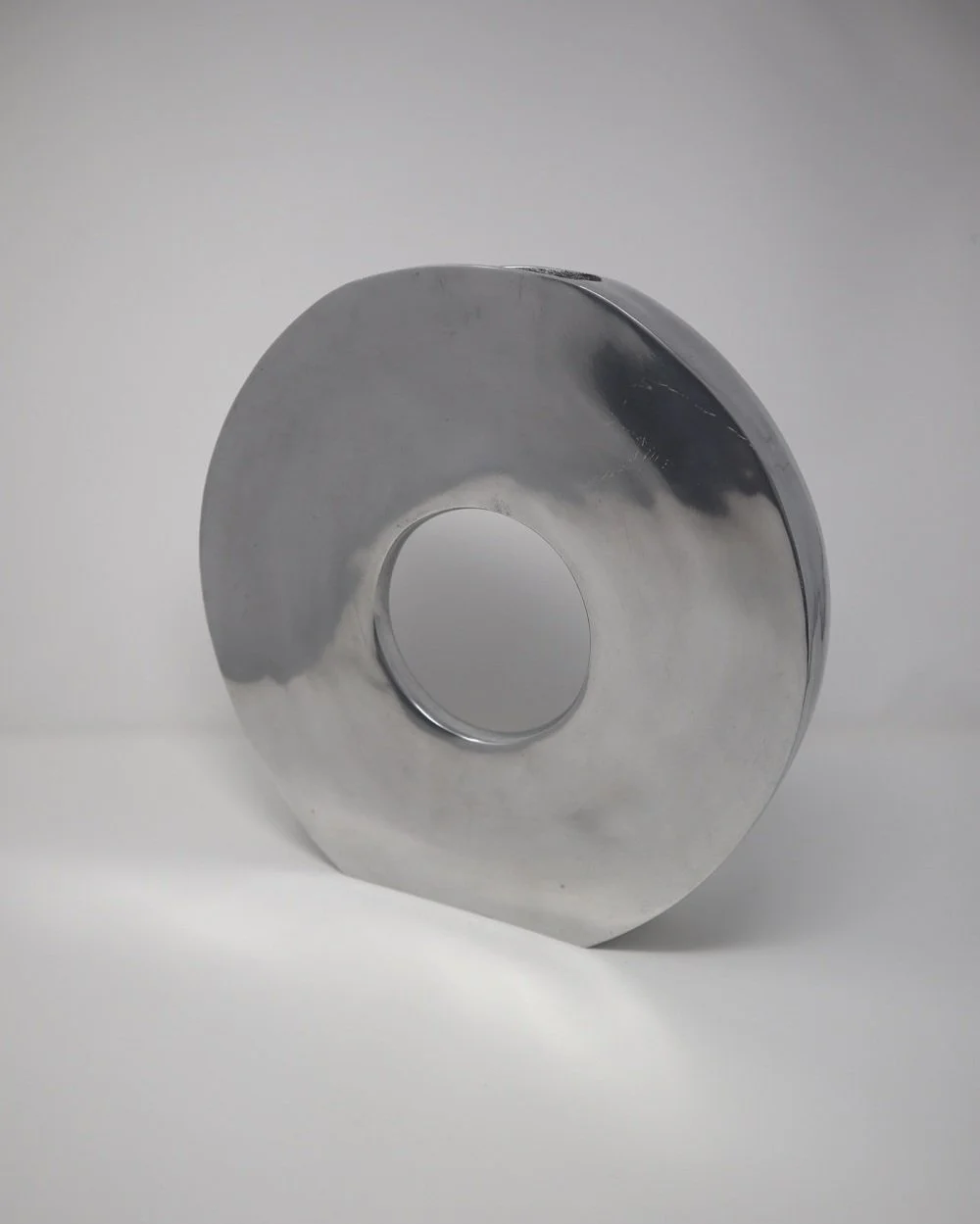 Large, Modernist style circular aluminium doughnut decorative vase.