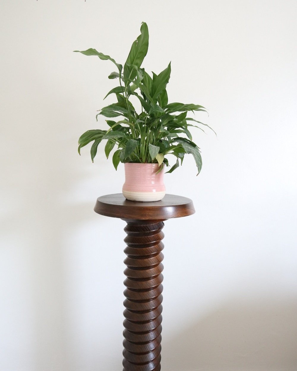 A large, turned wooden screw pedestal plinth to display plants or art. Circa 1970s.