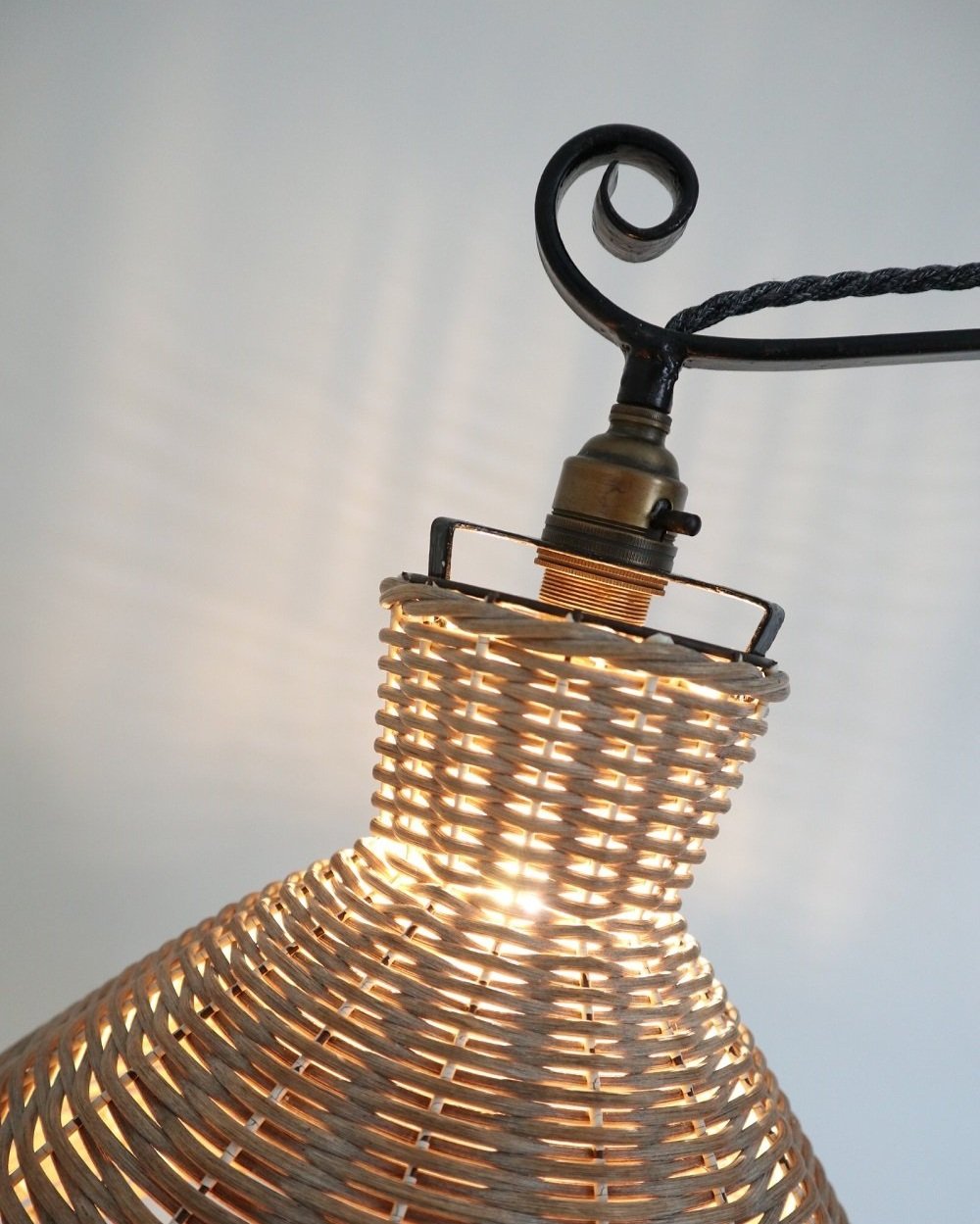 Wrought iron decorative reading floor lamp with rattan shade. Lamp base circa 1940s.